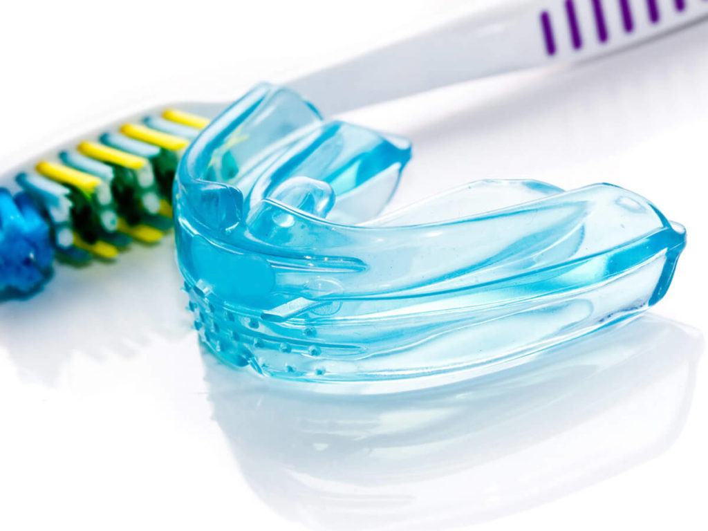 Mouthguard next to a toothbrush